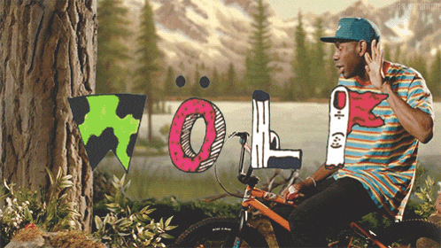 a man sitting on a bike with the word wolf written on the front