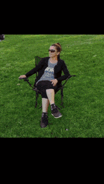 a woman sitting in a chair with a shirt that says york on it