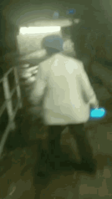 a blurry picture of a person standing in a dark room .