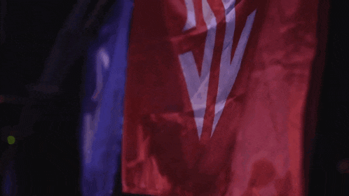 a red blue and white flag with a white triangle on it