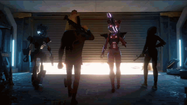 a group of people are standing in a garage with robots