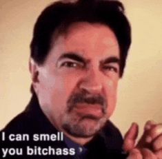 a man with a beard is making a funny face and saying `` i can smell you bitchass ''