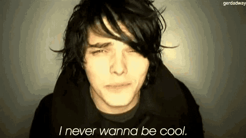 a man with black hair is making a funny face and saying `` i never wanna be cool '' .