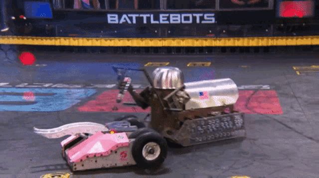 a battlebots game is being played on a concrete floor