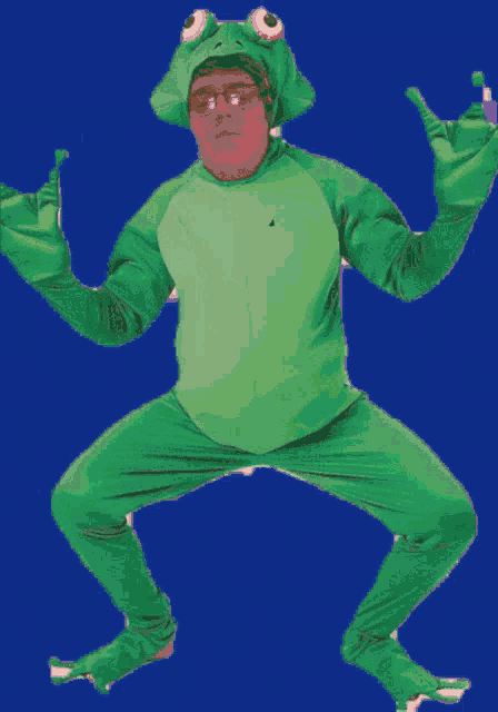 a man in a green frog costume with a crown on his head