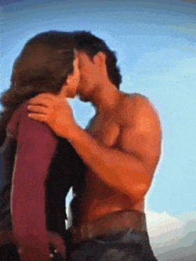 a man and a woman are kissing in a painting