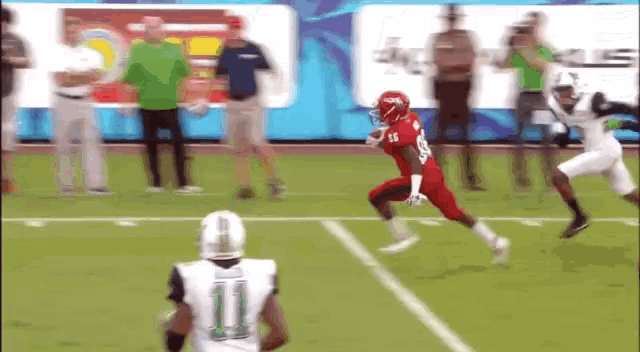 a football player with the number 11 on his jersey runs on the field
