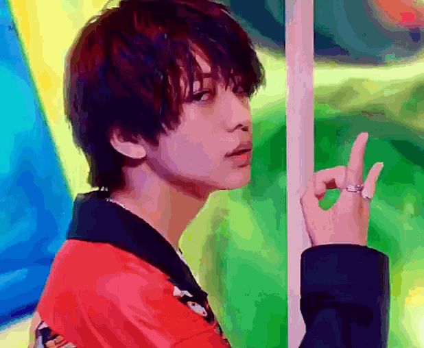 a young man with a ring on his finger is giving the peace sign
