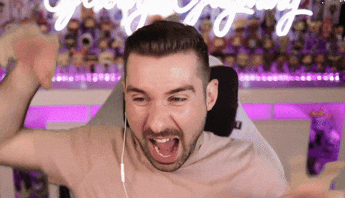 a man wearing headphones is screaming in front of a neon sign that says " victory "