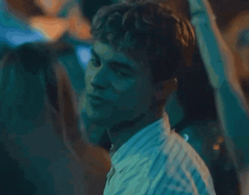 a close up of a man 's face in a crowd