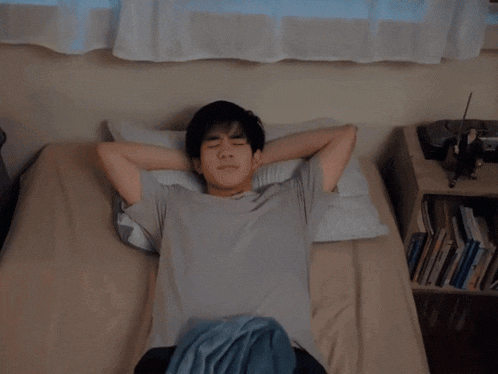 a blurry image of a person laying on a bed
