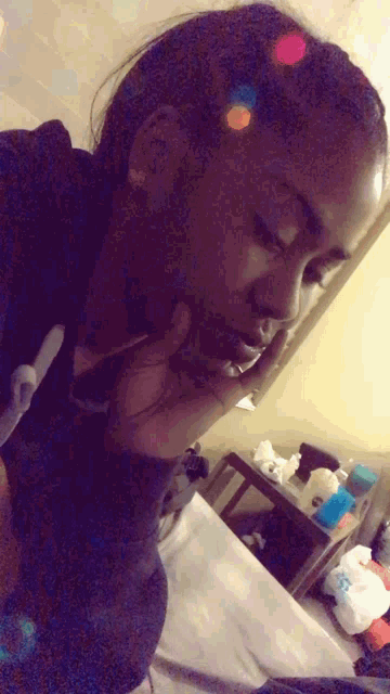 a woman laying on a bed talking on a cellphone