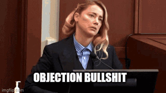 a woman is giving a speech in front of a microphone and the words objection bullshit are above her