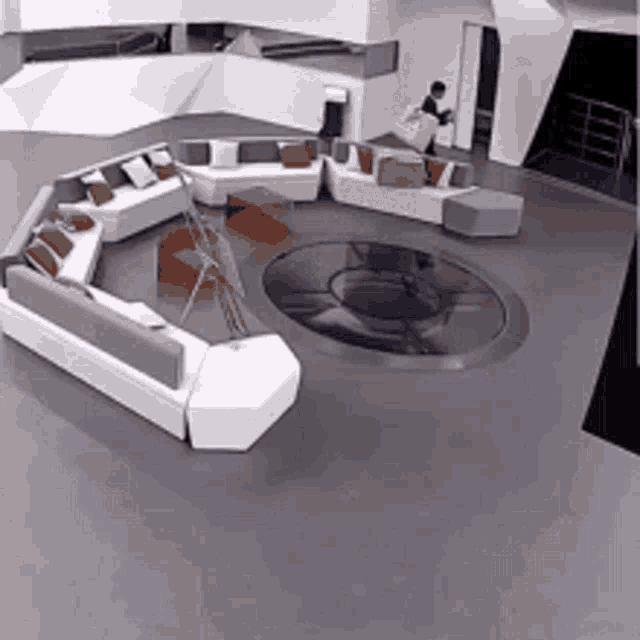 a living room with a lot of furniture and a man standing in the middle