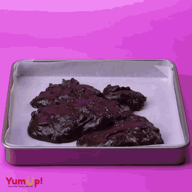 a tray of chocolate cookie dough with the words yum up written on the bottom