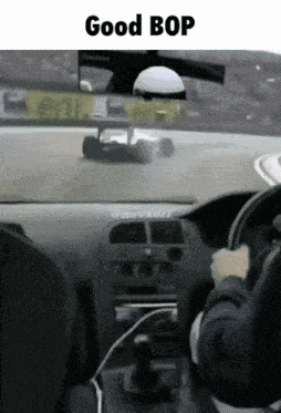 a person driving a car with the words " good bop " on the bottom