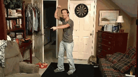 a man is dancing in front of a dart board
