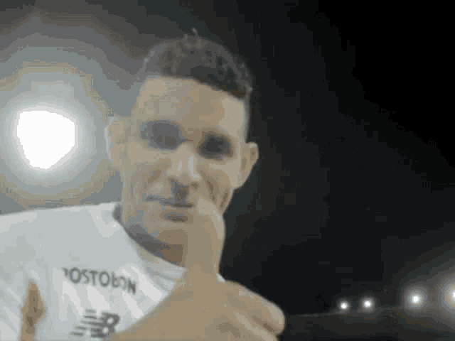 a man giving a thumbs up wearing a jersey that says postobon on it