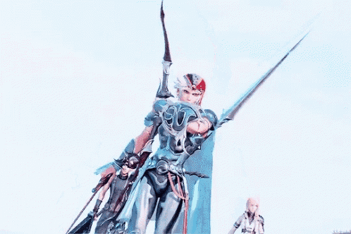a man in armor is holding a sword in his hand .