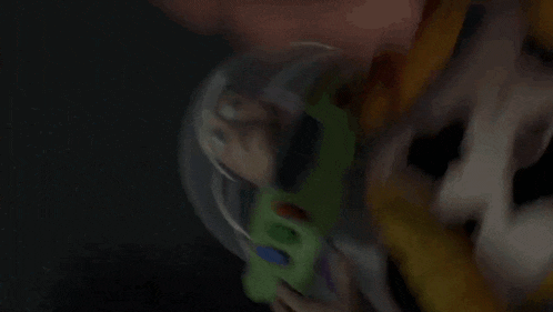 woody is holding buzz lightyear in his arms in a toy story scene