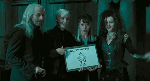 a group of people holding a sign that says " harry potter short day 99 "
