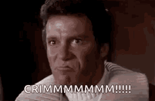 a man is making a funny face and saying crimmmmmmmm !!!