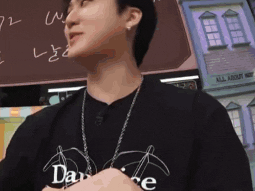 a man wearing a black t-shirt that says dance on it