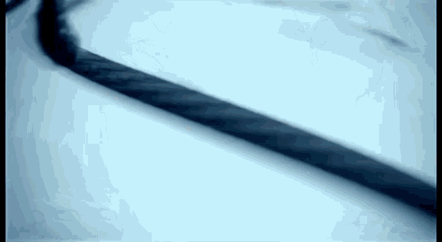 a close up of a smoke coming out of a rope on a white surface .
