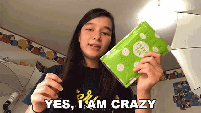 a girl is holding a package that says thank you and says yes i am crazy