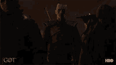 a group of people walking in the dark with a hbo logo on the bottom