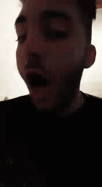 a man with a beard is wearing a black shirt with the word cc on it