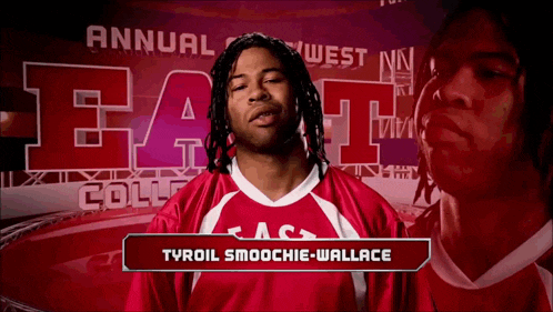 a man in a red and white jersey with the name tyroil smoochie-wallace on the bottom