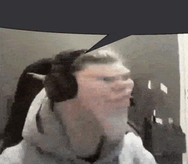 a man wearing headphones is talking with a speech bubble above him .