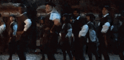 a group of people are dancing in front of a sign that says ' upside down party ' on it