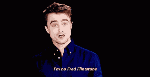 a man in a blue shirt says i 'm no fred flintstone but i can make your bed rock