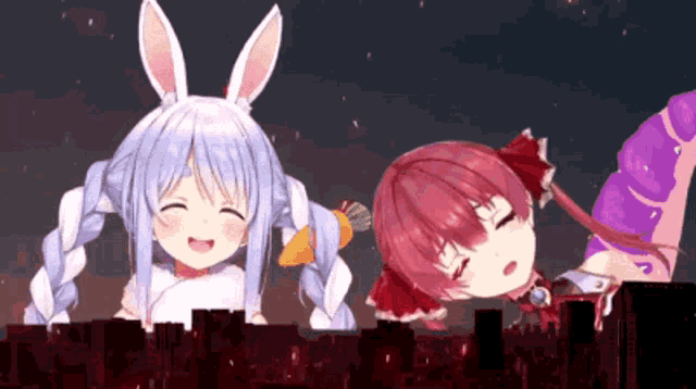 a couple of anime girls standing next to each other .