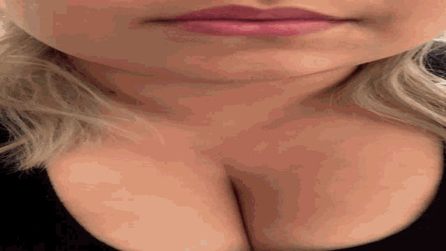 a close up of a woman 's face with her mouth open