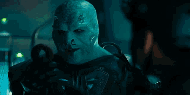 a man with horns on his head is looking at another man