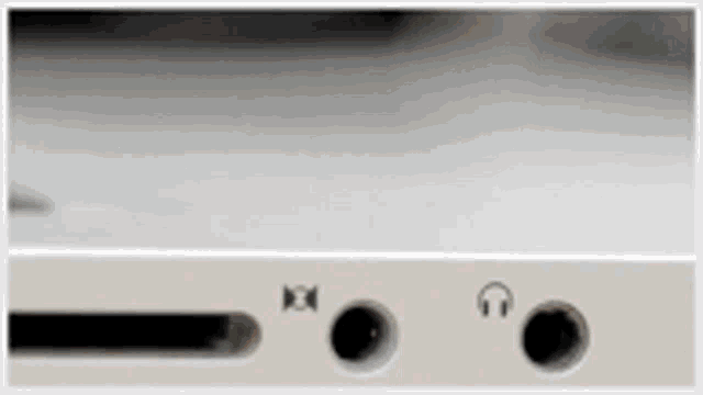 a close up of a headphone jack and a sd card slot