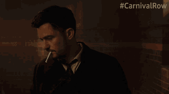 a man lighting a cigarette with the hashtag #carnivalrow on the bottom
