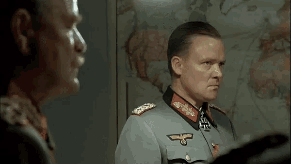 a man in a military uniform with an eagle on his collar