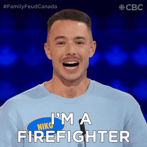 a man wearing a blue shirt that says i 'm a firefighter on it