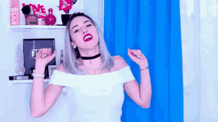 a woman in a white off the shoulder top is dancing