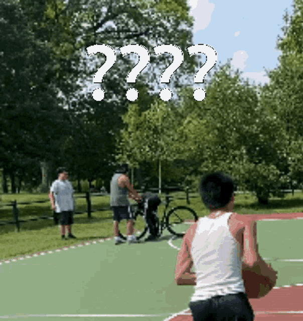 a man holding a basketball on a basketball court with a question mark above him