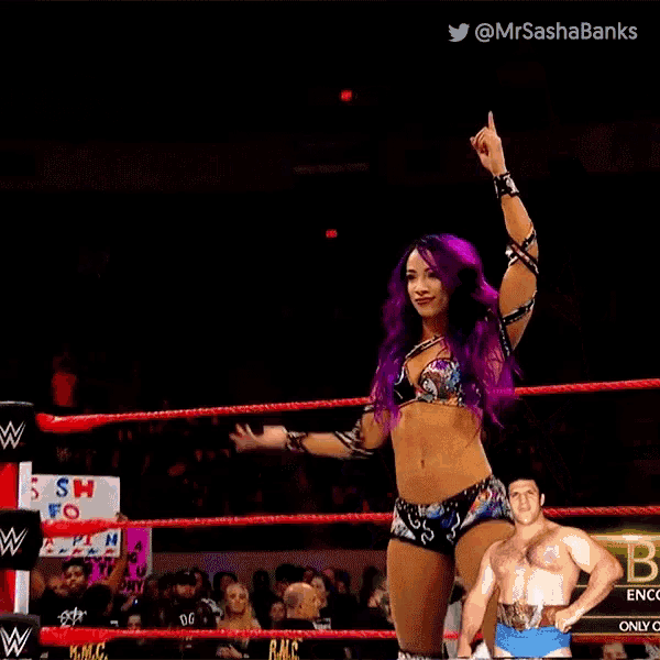 a woman with purple hair and a man in a wrestling ring