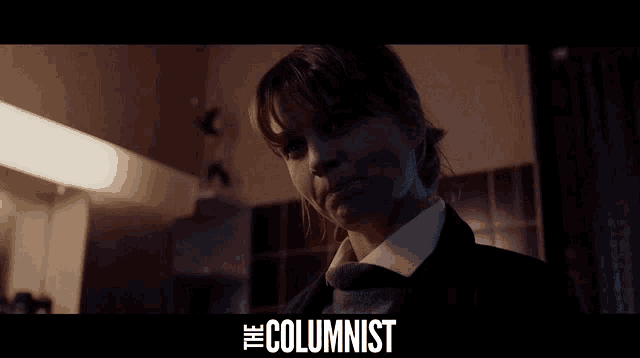 a woman in a dark room with the words " the columnist " on the bottom