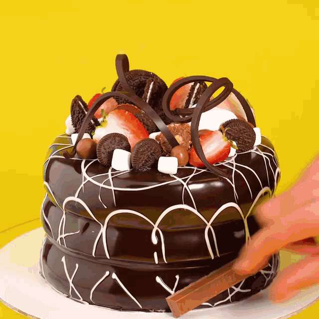 a chocolate cake with strawberries and oreos on it