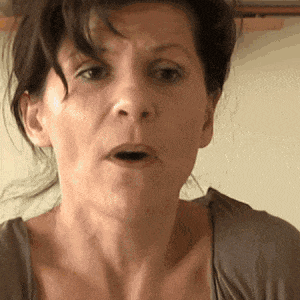 a close up of a woman making a funny face