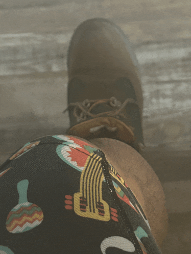 a person wearing a pair of colorful shorts with a guitar on them