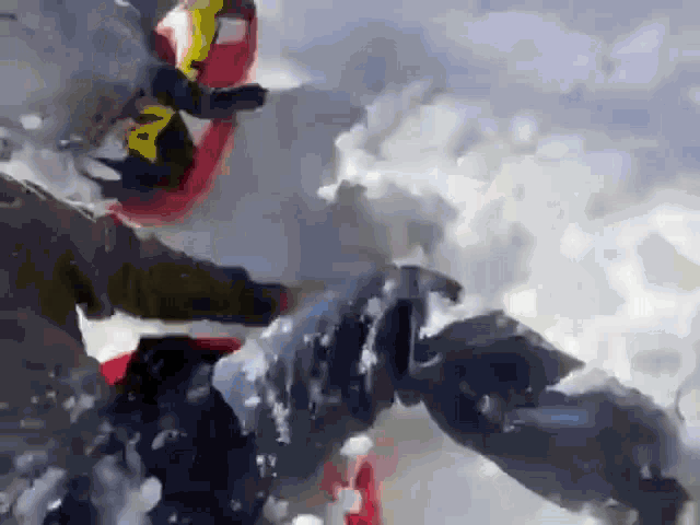 a person is riding a snowmobile in the snow while wearing a helmet .